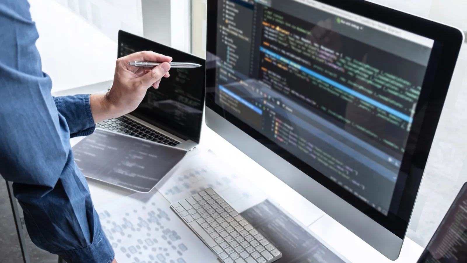 Agent working on a laptop with property listings